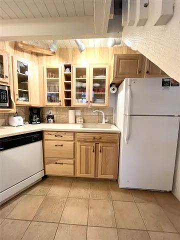 a kitchen with a sink a stove and cabinets