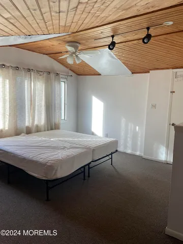 a bedroom with a bed and a ceiling fan