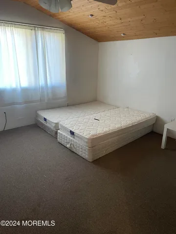 a room with a bed and window