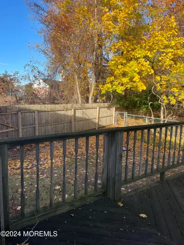 a view of outdoor space with deck and a yard