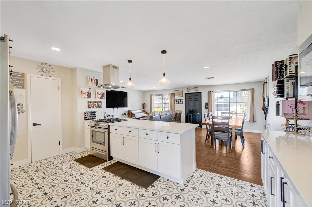 1331 Pinto Road Boulder City, NV 89005 - Photo 21 of 46 A well-lit, open-concept kitchen and dining area feature a central island and contemporary fixtures.
