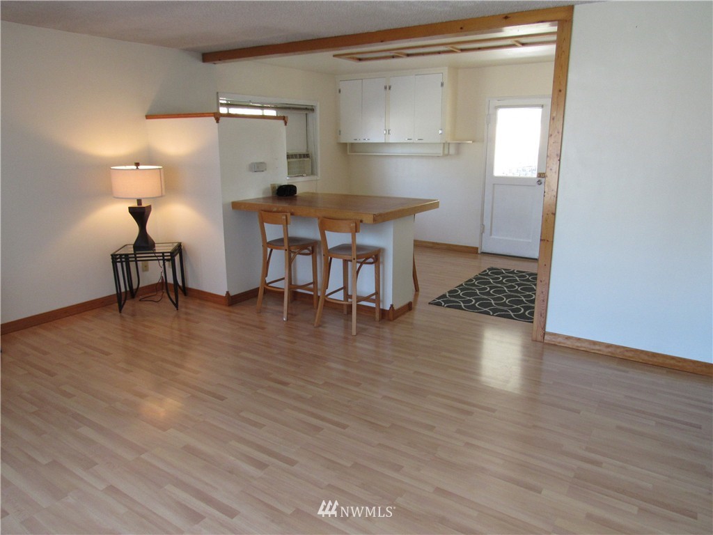 2107 Northeast 9th Street Renton, WA 98056 - Photo 3 of 19 a view of a room with wooden floor table and chairs