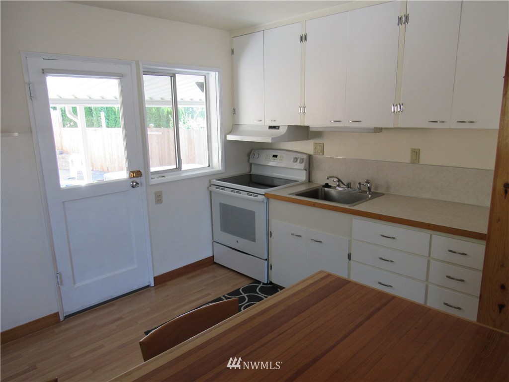 2107 Northeast 9th Street Renton, WA 98056 - Photo 8 of 19 a kitchen with cabinets appliances and a window