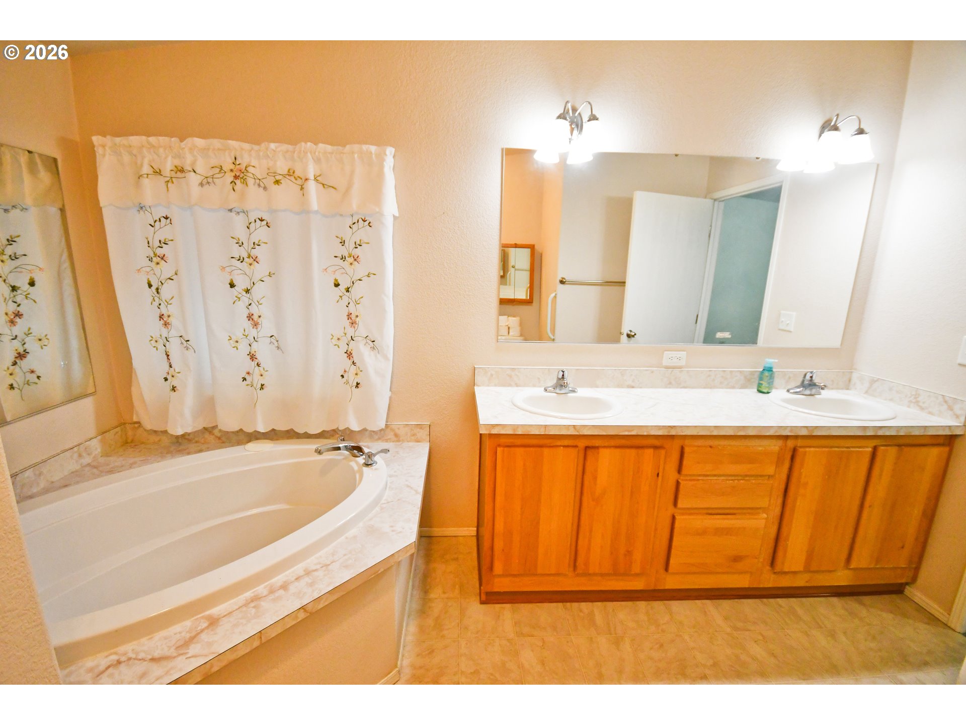 755 Division Street, Unit 322 The Dalles, OR 97058 - Photo 8 of 14 a bathroom with a tub a sink and a mirror