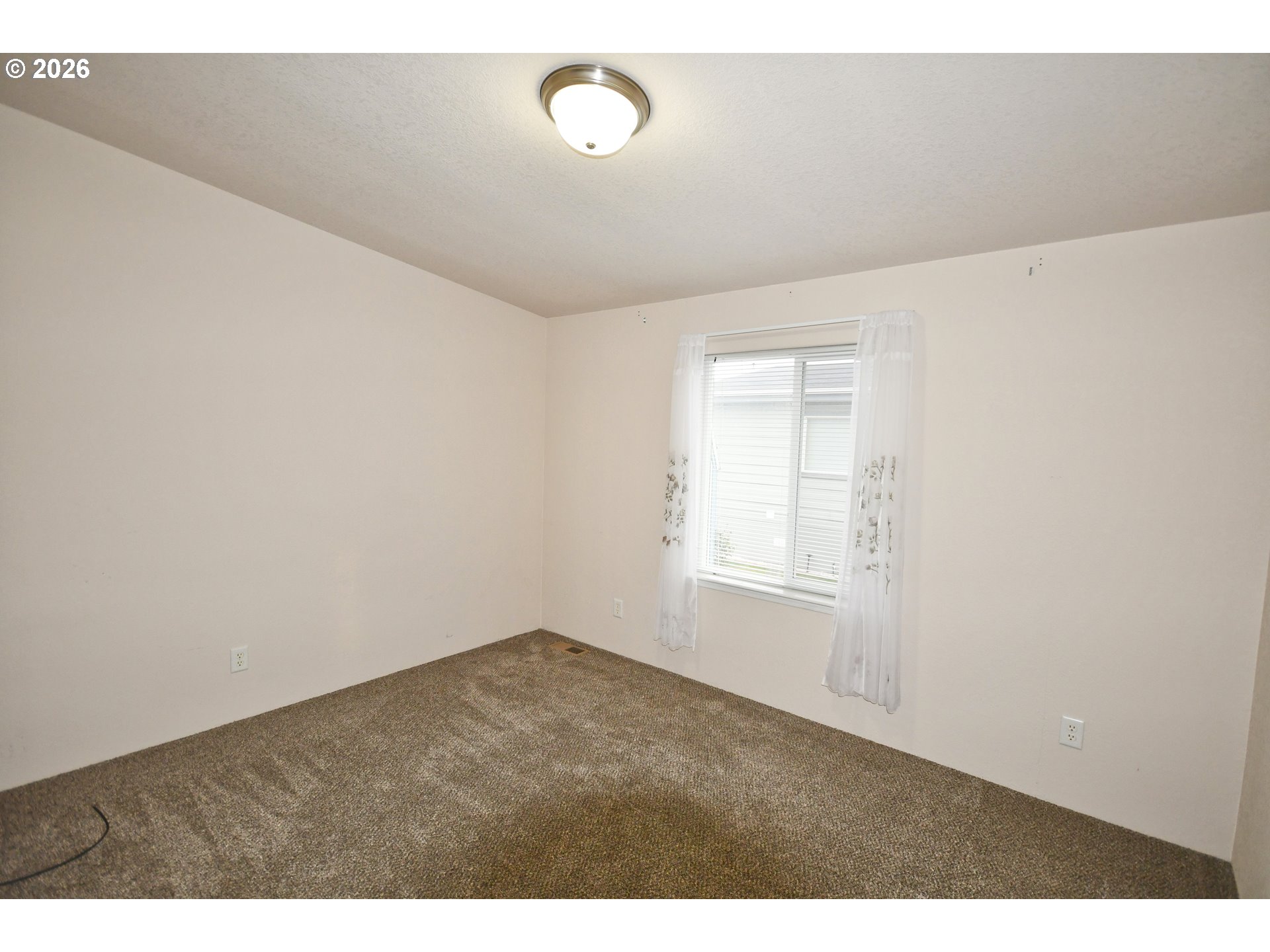 755 Division Street, Unit 322 The Dalles, OR 97058 - Photo 10 of 14 a view of an empty room with a window