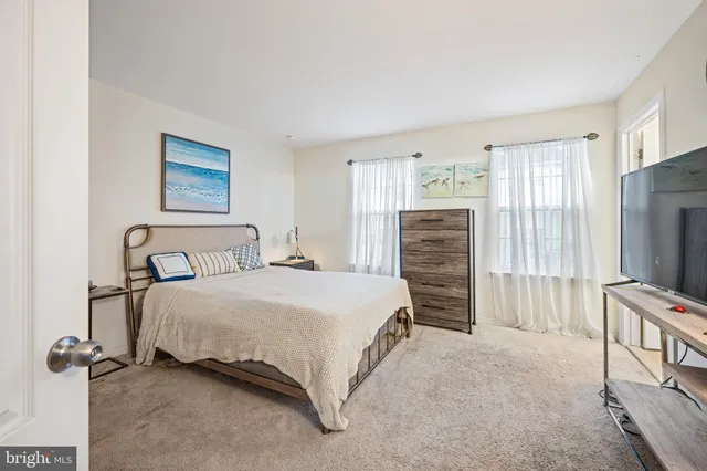 a bedroom with a bed and a television