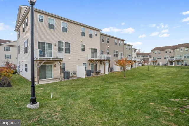 a view of a house with a yard and sitting area