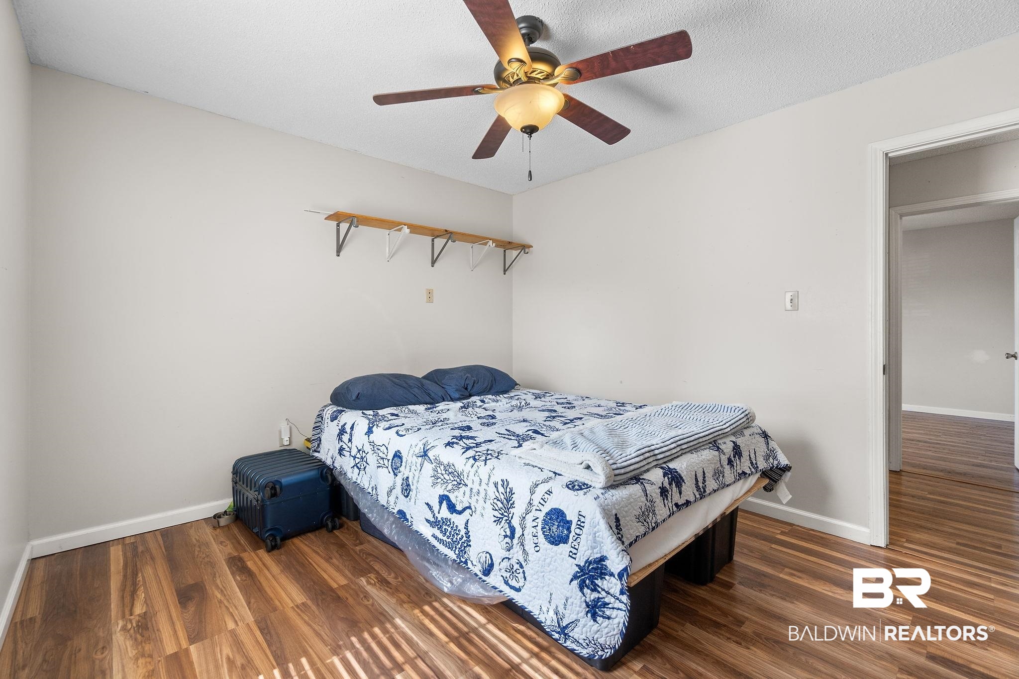 33135 Collier Road Lillian, AL 36549 - Photo 24 of 30 Bedroom with dark wood finished floors and ceiling fan