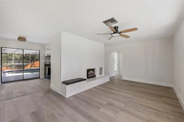 a view of a livingroom with a fireplace and wooden floor