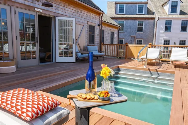 a view of a house with pool and sitting area