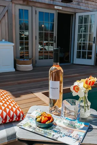 a view of a house with couches chairs and a yard