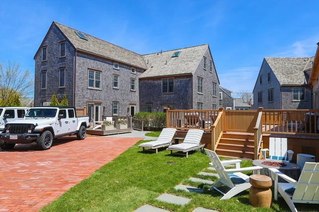 a view of house with outdoor seating space and wooden fence