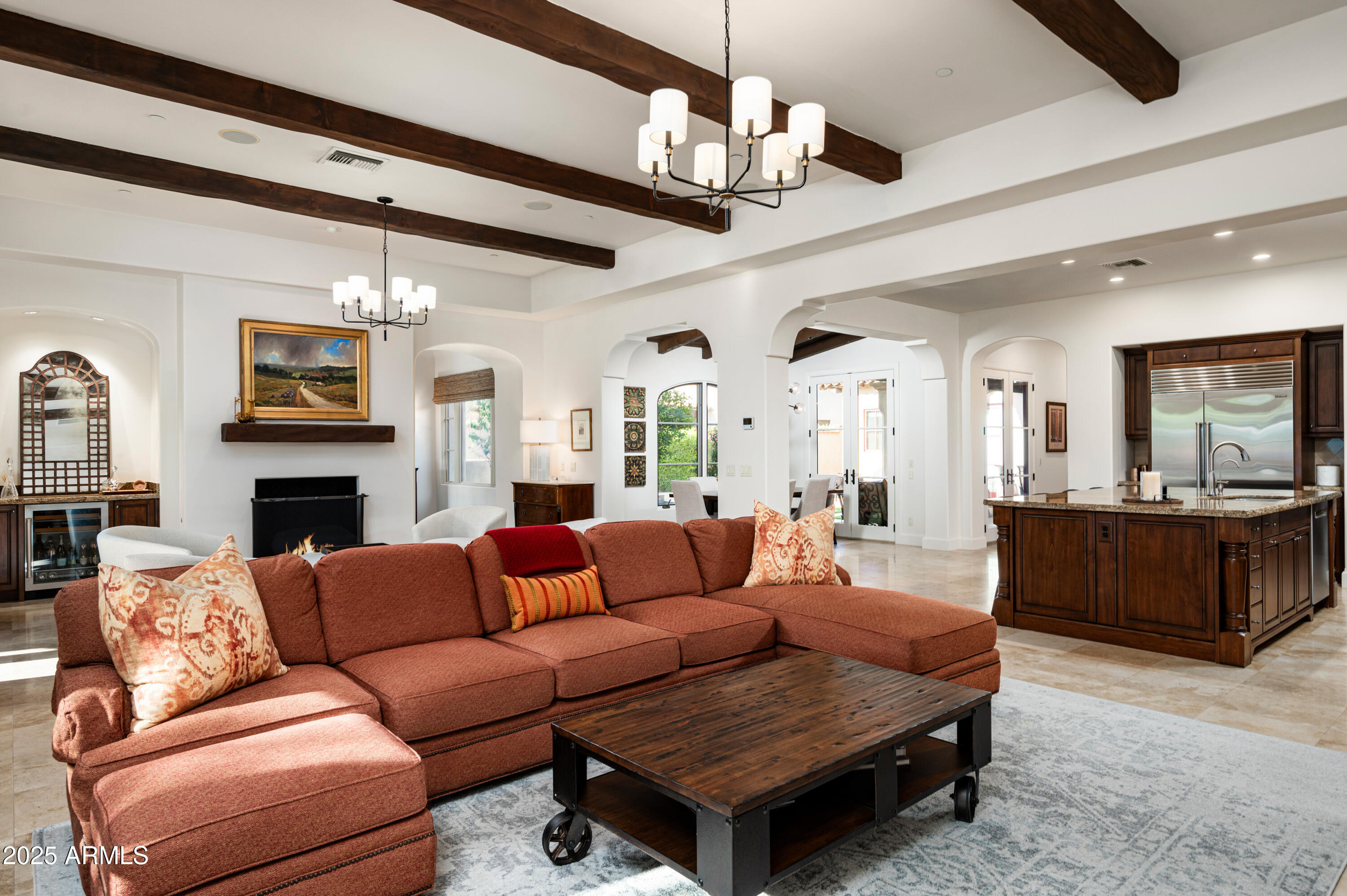20263 North 102nd Place Scottsdale, AZ 85255 - Photo 12 of 58 a living room with furniture a fireplace and a chandelier
