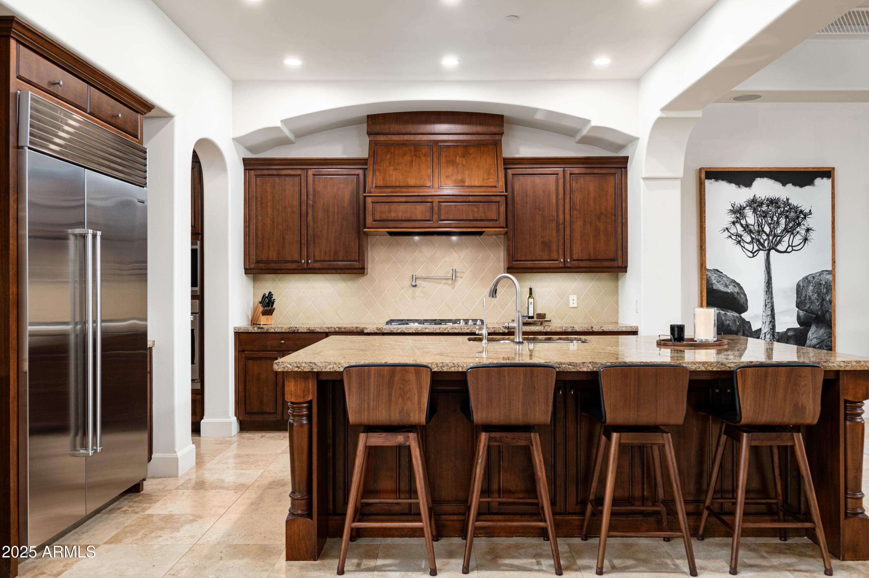 20263 North 102nd Place Scottsdale, AZ 85255 - Photo 13 of 58 a kitchen with granite countertop a table chairs stove and cabinets
