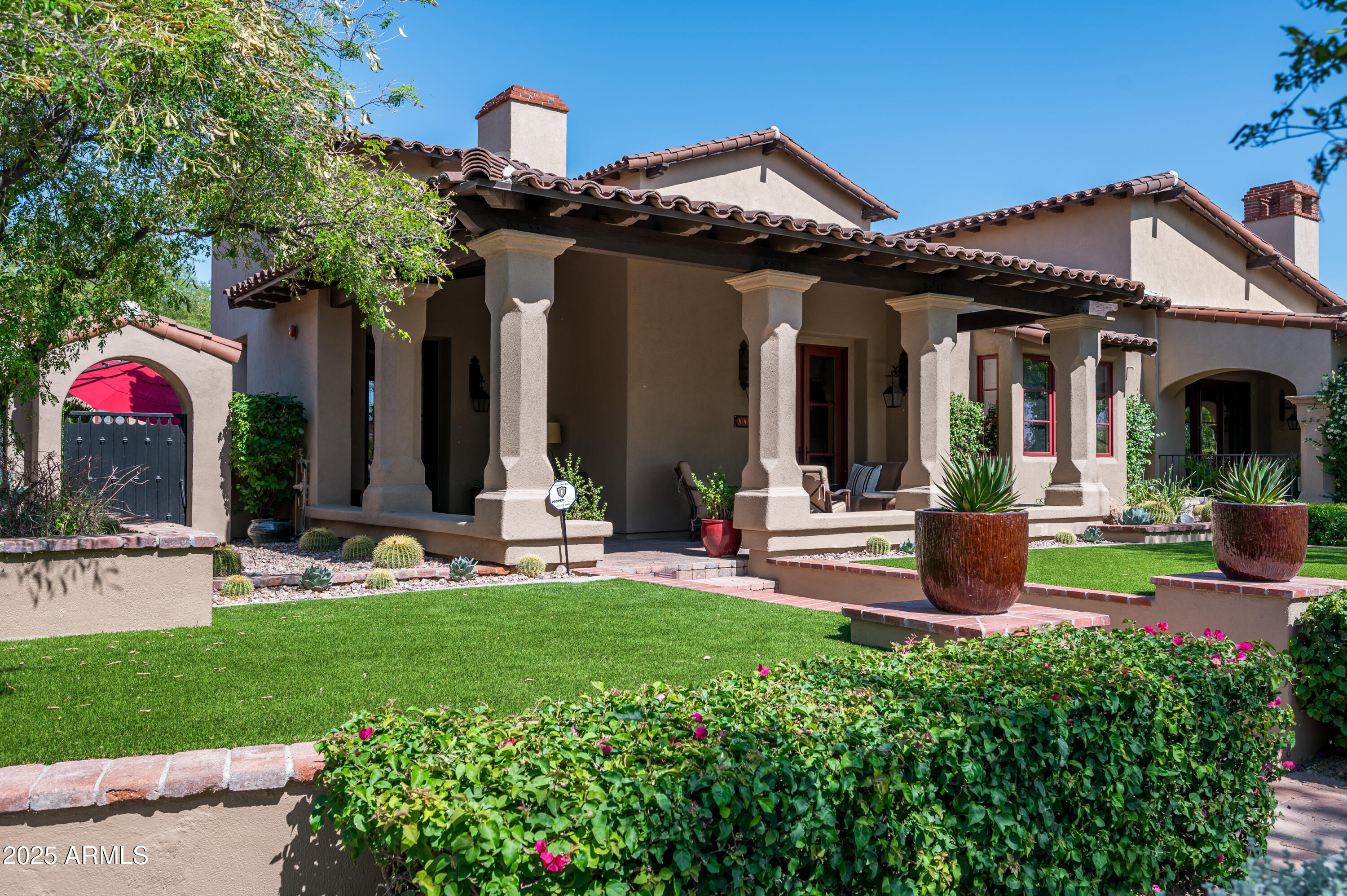 20263 North 102nd Place Scottsdale, AZ 85255 - Photo 44 of 58 a front view of a house with swimming pool and garden
