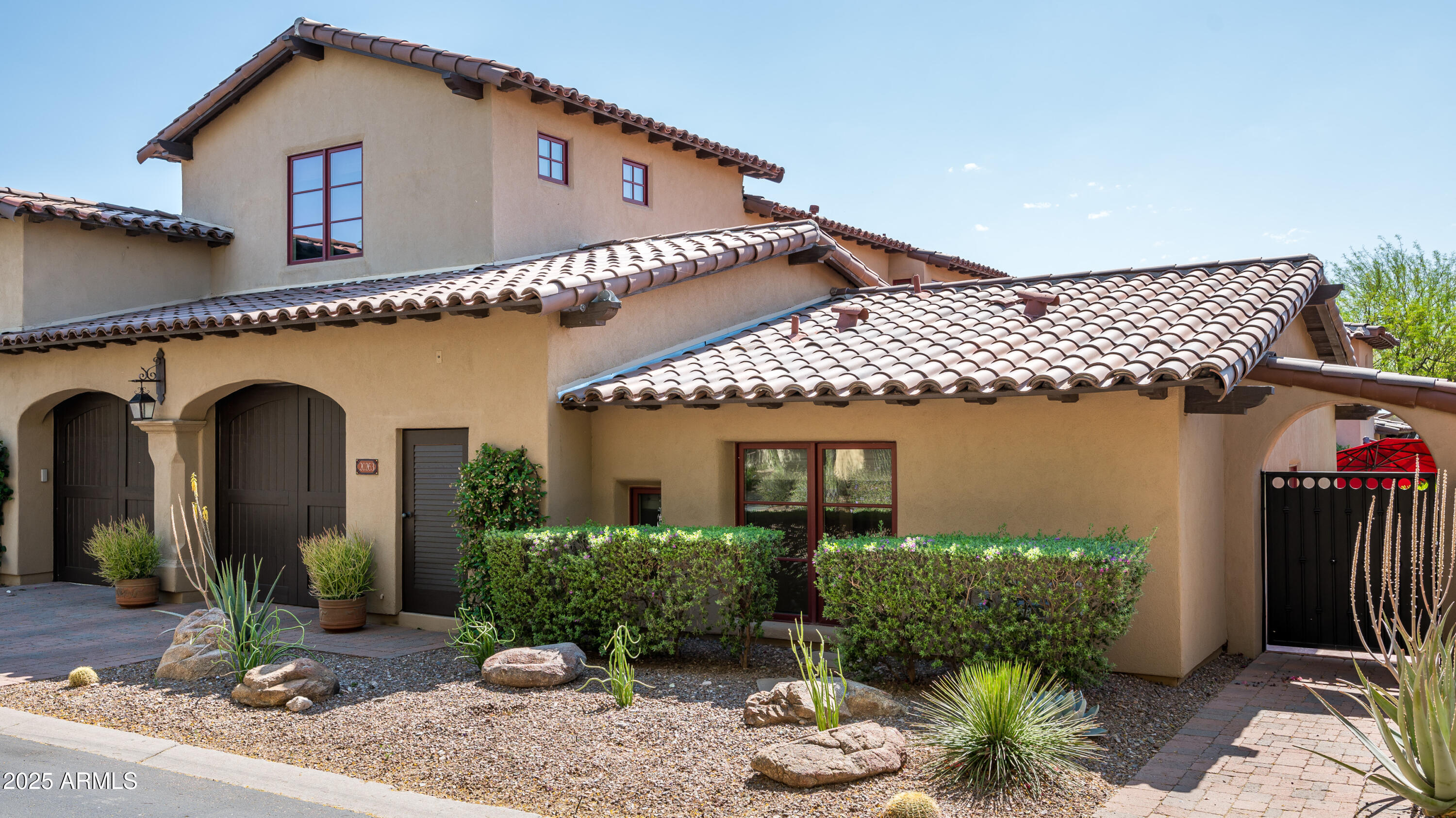 20263 North 102nd Place Scottsdale, AZ 85255 - Photo 52 of 58 a front view of a house with plants and outdoor seating