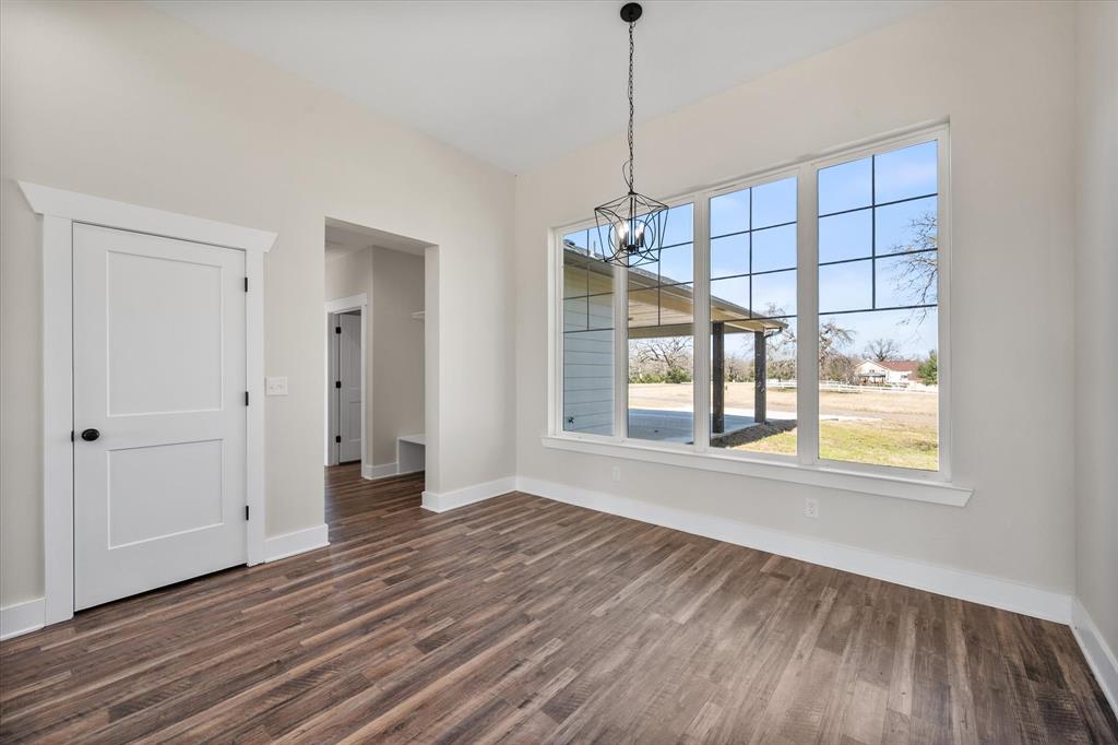 4003 Nettle Road Streetman, TX 75859 - Photo 12 of 33 a view of an empty room with wooden floor and a window