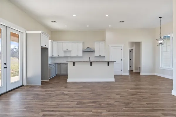 a view of kitchen with wooden floor and electronic appliances