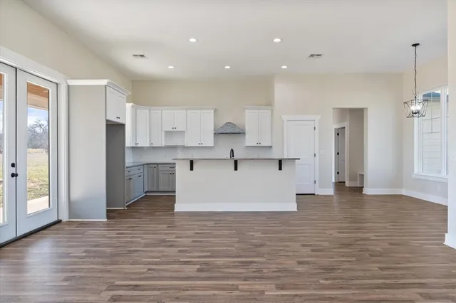 a view of kitchen with wooden floor and electronic appliances