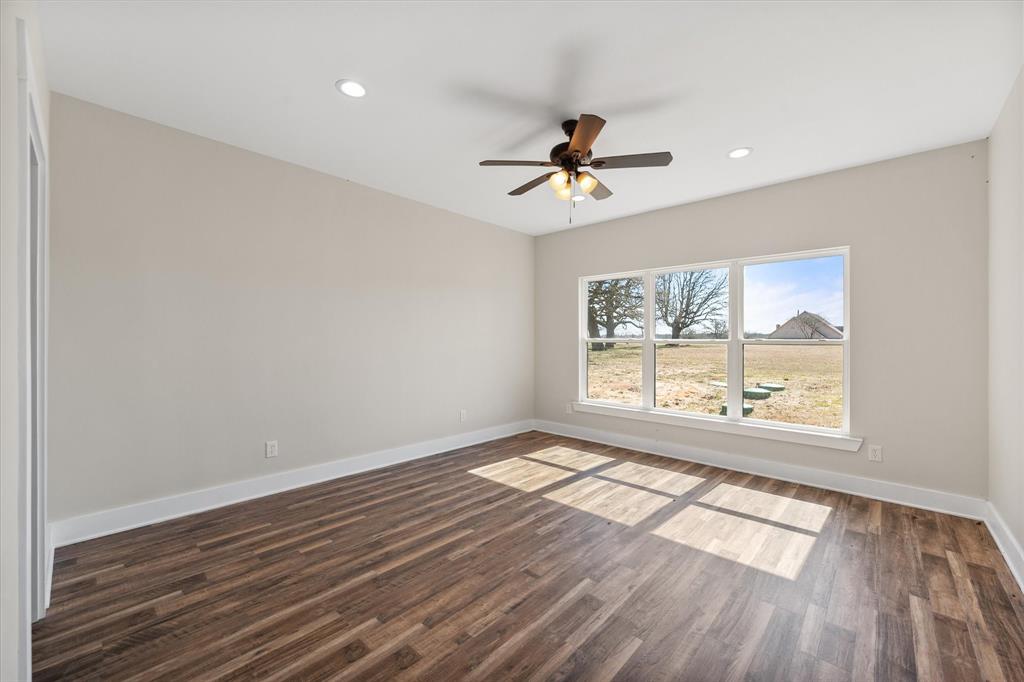4003 Nettle Road Streetman, TX 75859 - Photo 17 of 33 a view of an empty room with wooden floor and a window