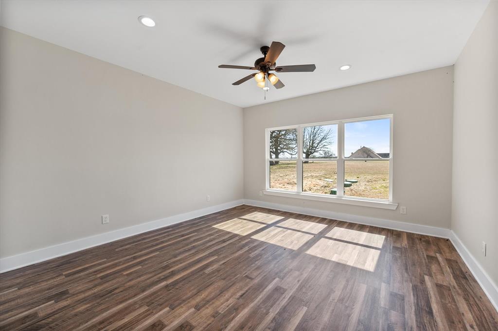 4003 Nettle Road Streetman, TX 75859 - Photo 18 of 33 a view of an empty room with wooden floor and a window