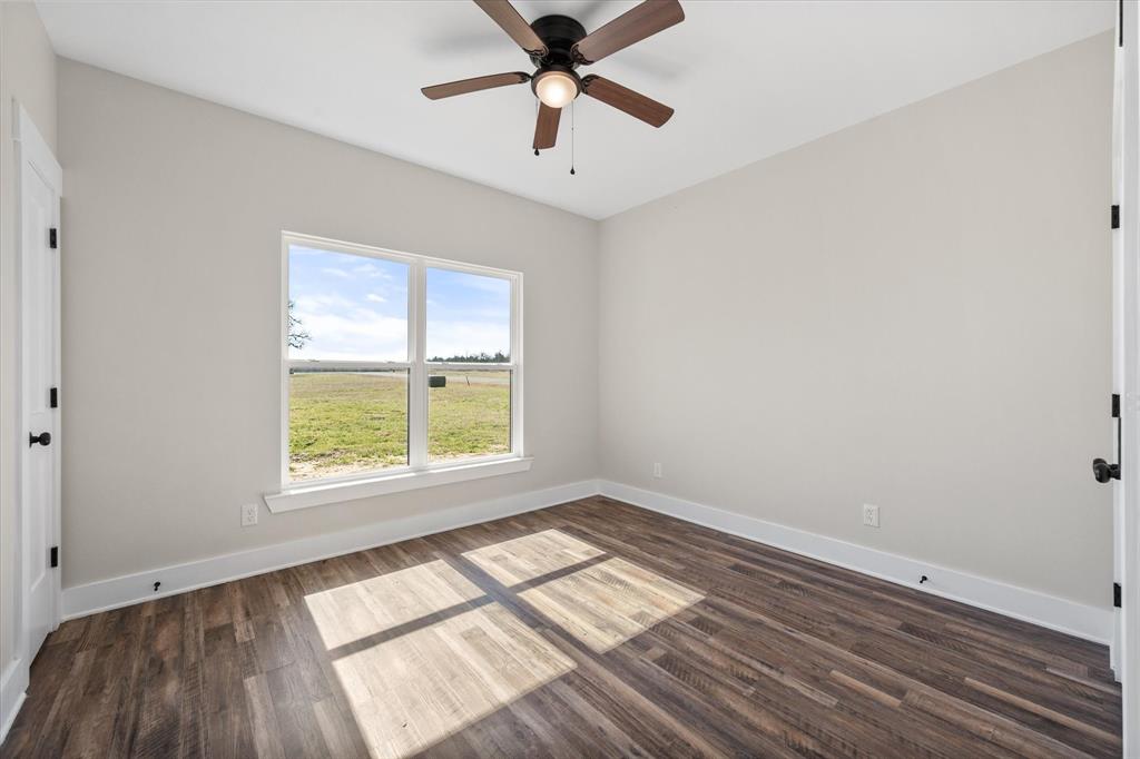 4003 Nettle Road Streetman, TX 75859 - Photo 22 of 33 an empty room with a window and a ceiling fan