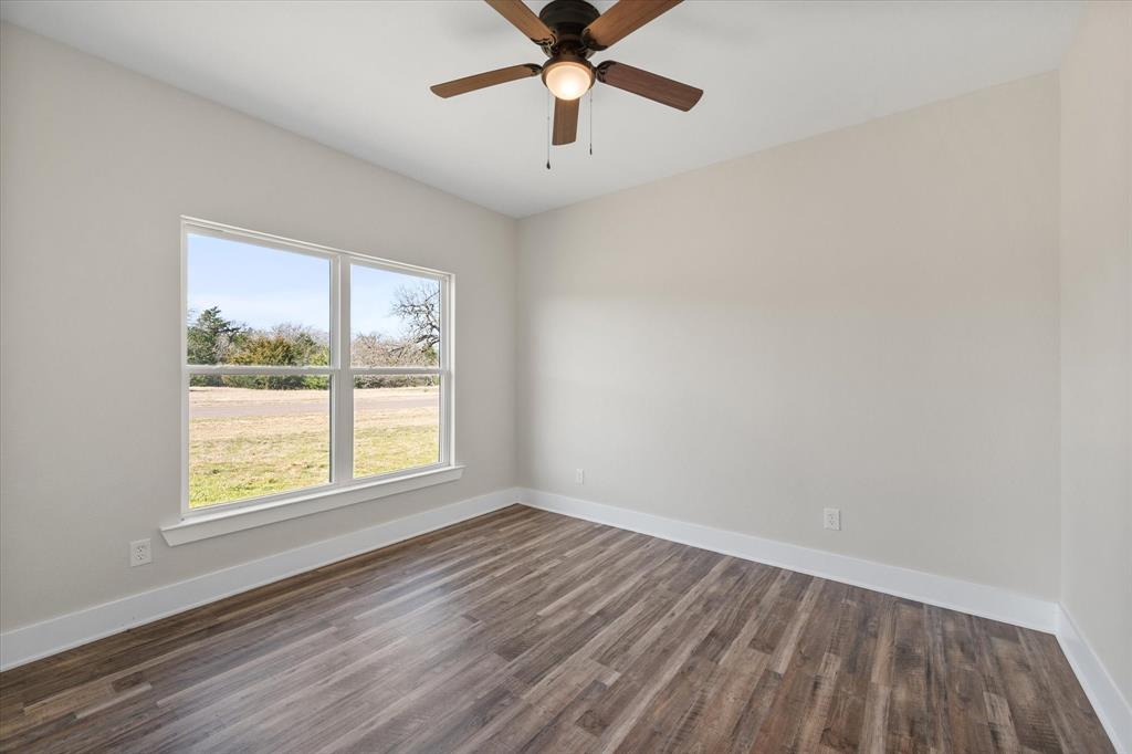 4003 Nettle Road Streetman, TX 75859 - Photo 25 of 33 wooden floor in an empty room with a window