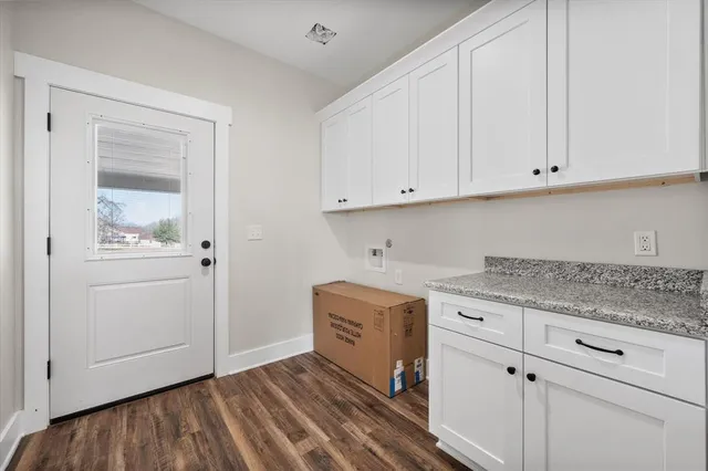 a kitchen with granite countertop white cabinets and sink