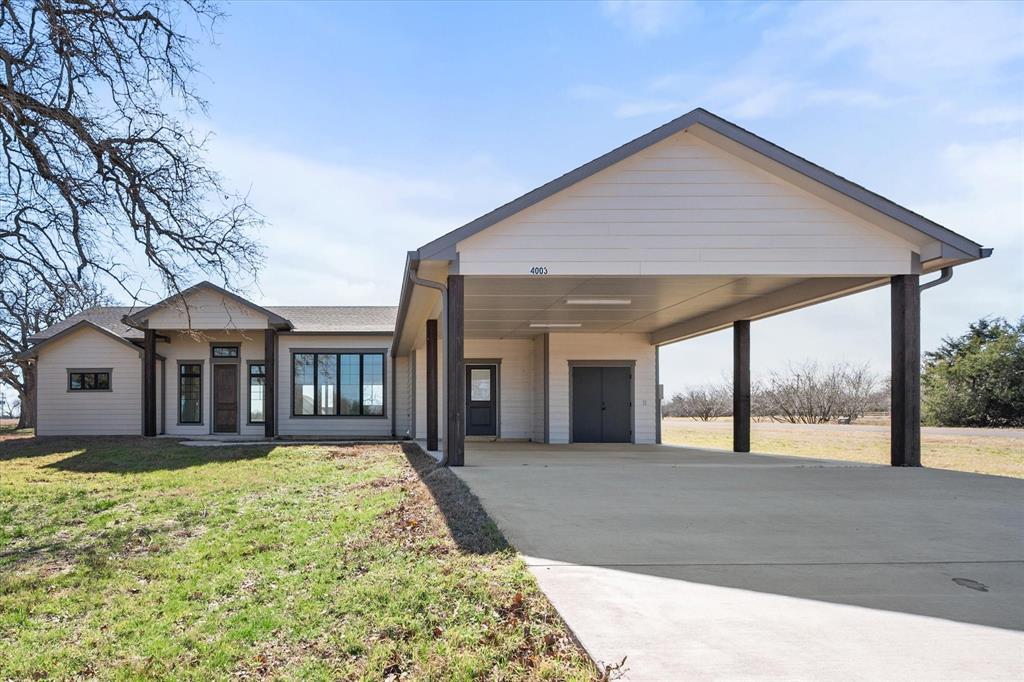 4003 Nettle Road Streetman, TX 75859 - Photo 31 of 33 a front view of a house with a yard and potted plants
