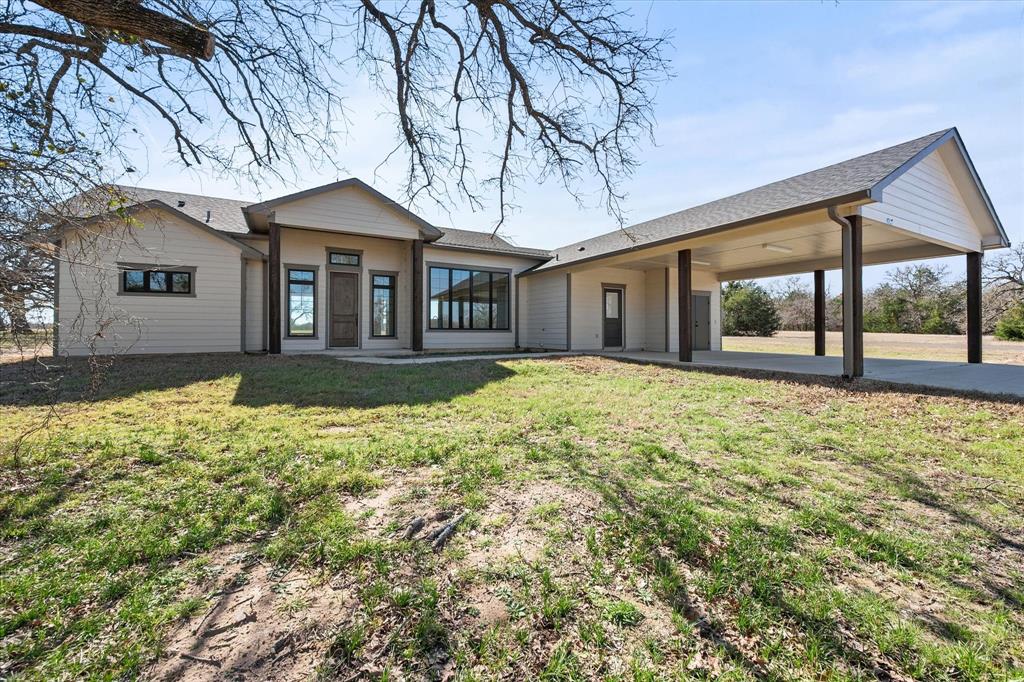 4003 Nettle Road Streetman, TX 75859 - Photo 32 of 33 a front view of a house with a yard and large tree