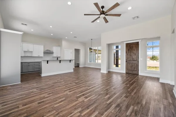 a view of a kitchen with wooden floor and a kitchen