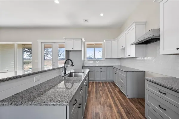 a kitchen that has a sink and a stove in it