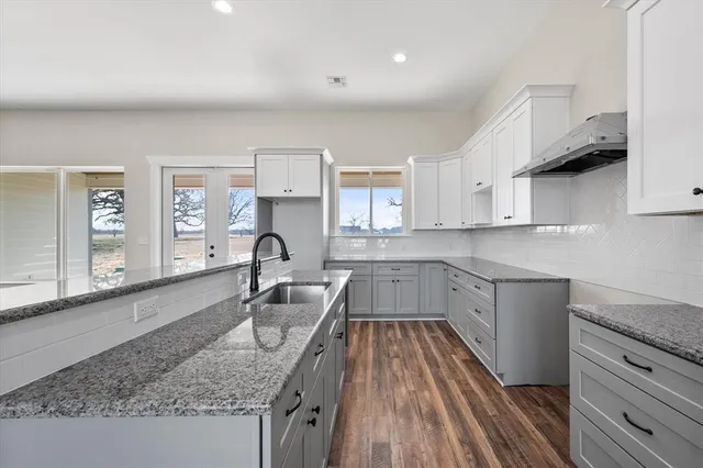a kitchen that has a sink and a stove in it