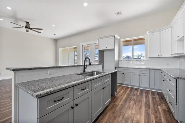 a kitchen with a sink stove and cabinets