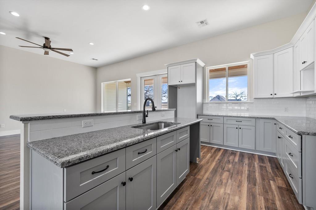 4003 Nettle Road Streetman, TX 75859 - Photo 10 of 33 a kitchen with a sink stove and cabinets