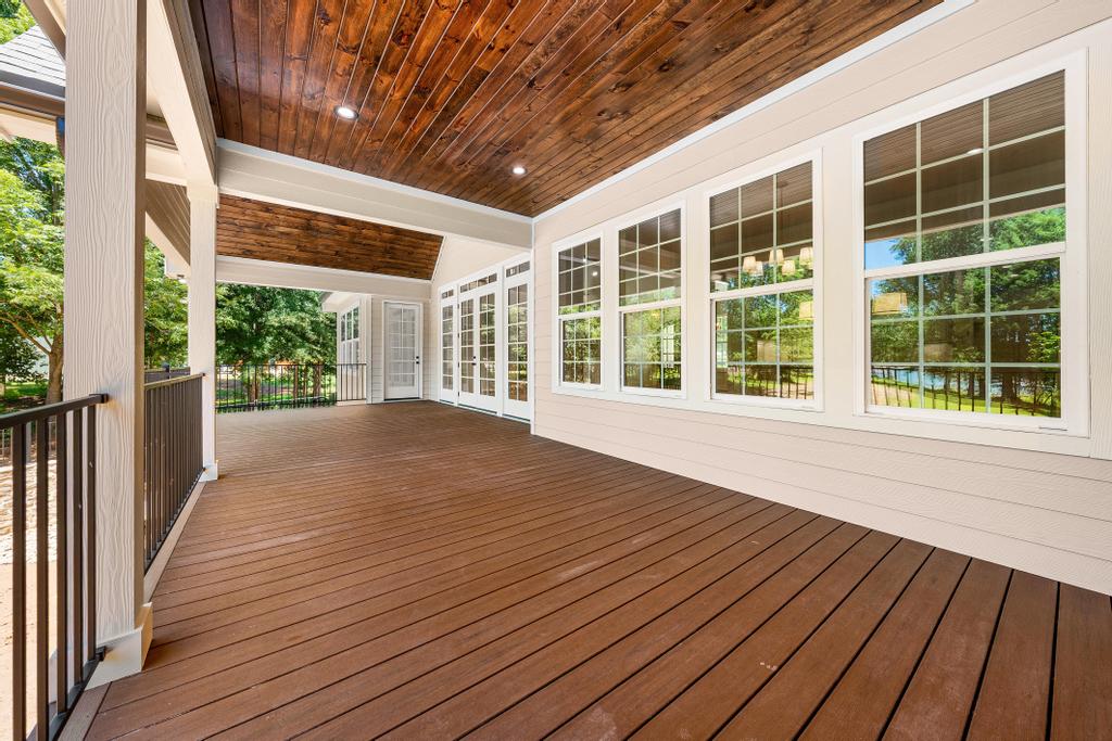 707 Vickery Street Extension Hartwell, GA 30643 - Photo 17 of 50 An inviting covered patio offers ample space for outdoor living, overlooking serene water views.
