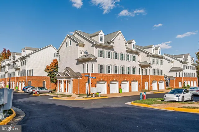 a view of residential houses with yard and swimming pool