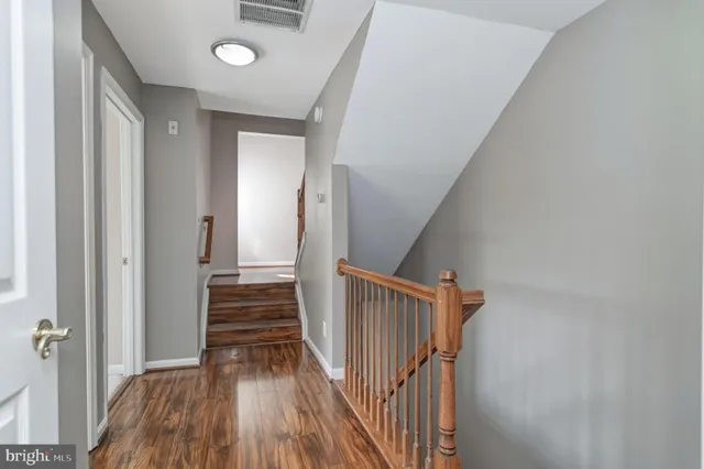 a view of a hallway view with wooden floor and staircase