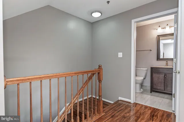 a view of a hallway view with wooden floor and staircase