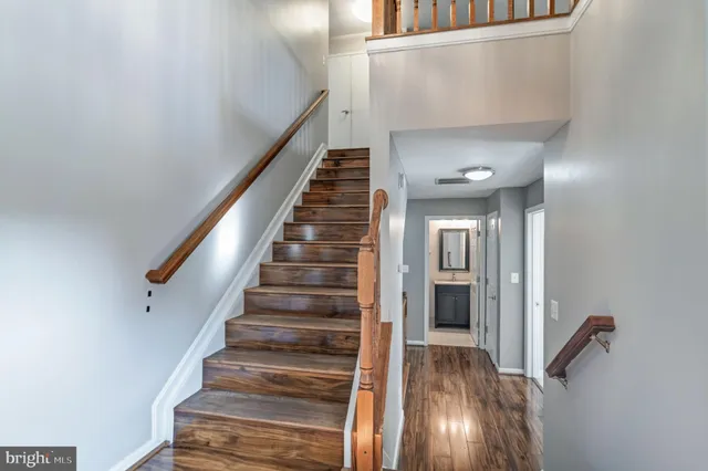 a view of entryway and hall with wooden floor