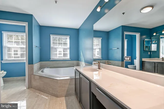 a bath tub sitting in a bathroom next to a window