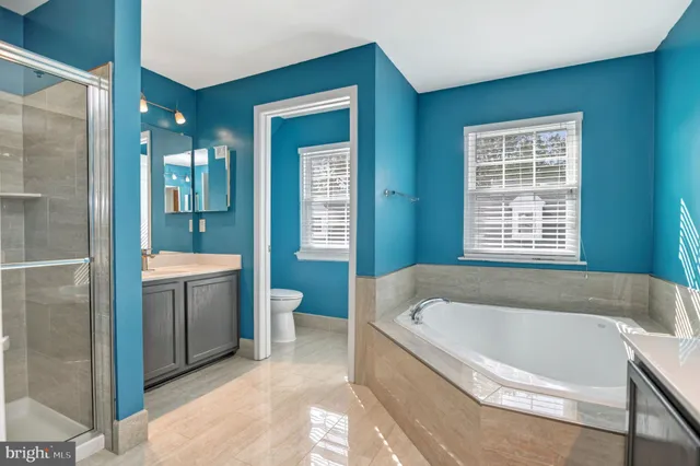 a spacious bathroom with a bathtub and sink
