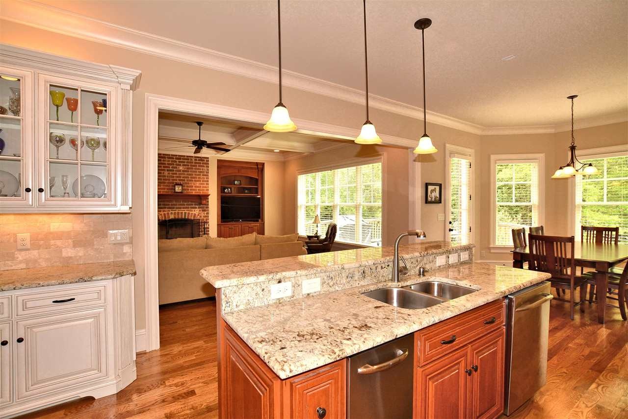1322 Dogwood Lane Raleigh, NC 27607 - Photo 9 of 30 Kitchen Island with complimenting Wood Finish, Raised Breakfast Bar, Pendant Lighting & Grohe Faucet.