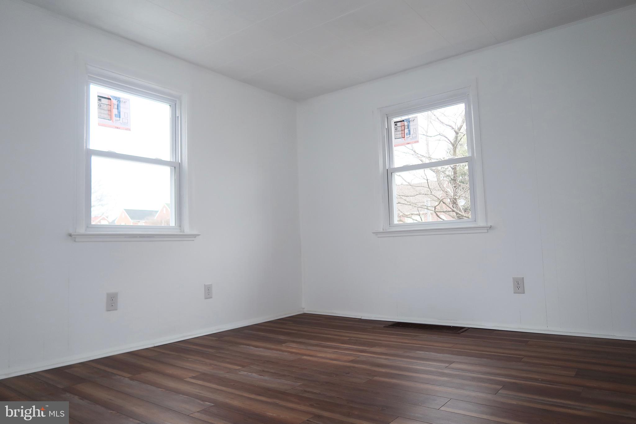 750 Oatman Street York, PA 17404 - Photo 11 of 33 an empty room with wooden floor and windows