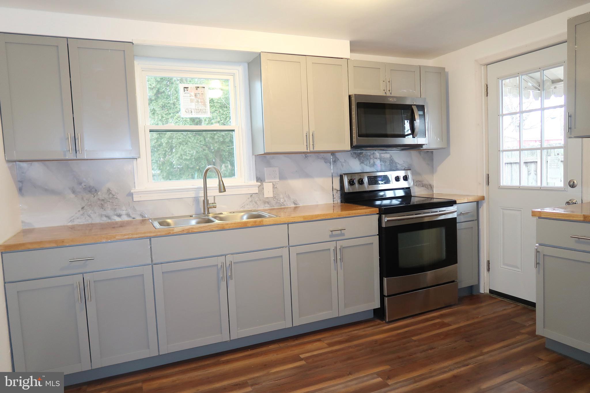 750 Oatman Street York, PA 17404 - Photo 13 of 33 a kitchen with white cabinets stainless steel appliances and window