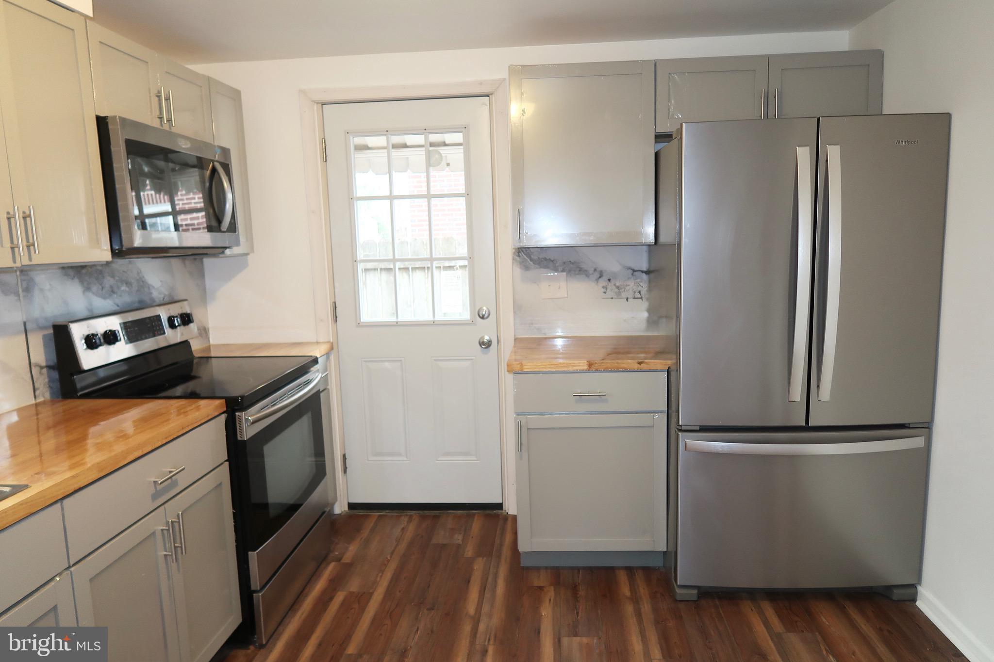 750 Oatman Street York, PA 17404 - Photo 15 of 33 a kitchen with a refrigerator stove and wooden cabinets