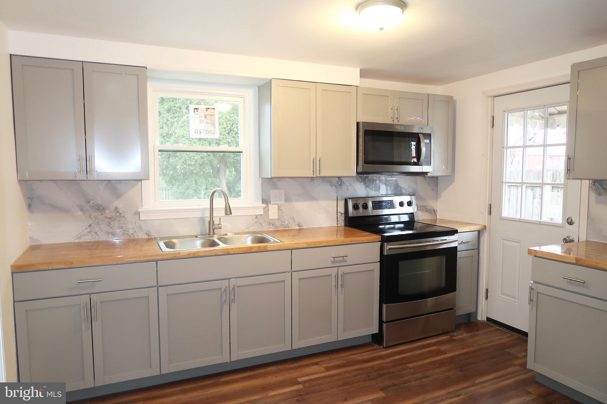 750 Oatman Street York, PA 17404 - Photo 16 of 33 a kitchen with stainless steel appliances granite countertop a sink and a stove top oven