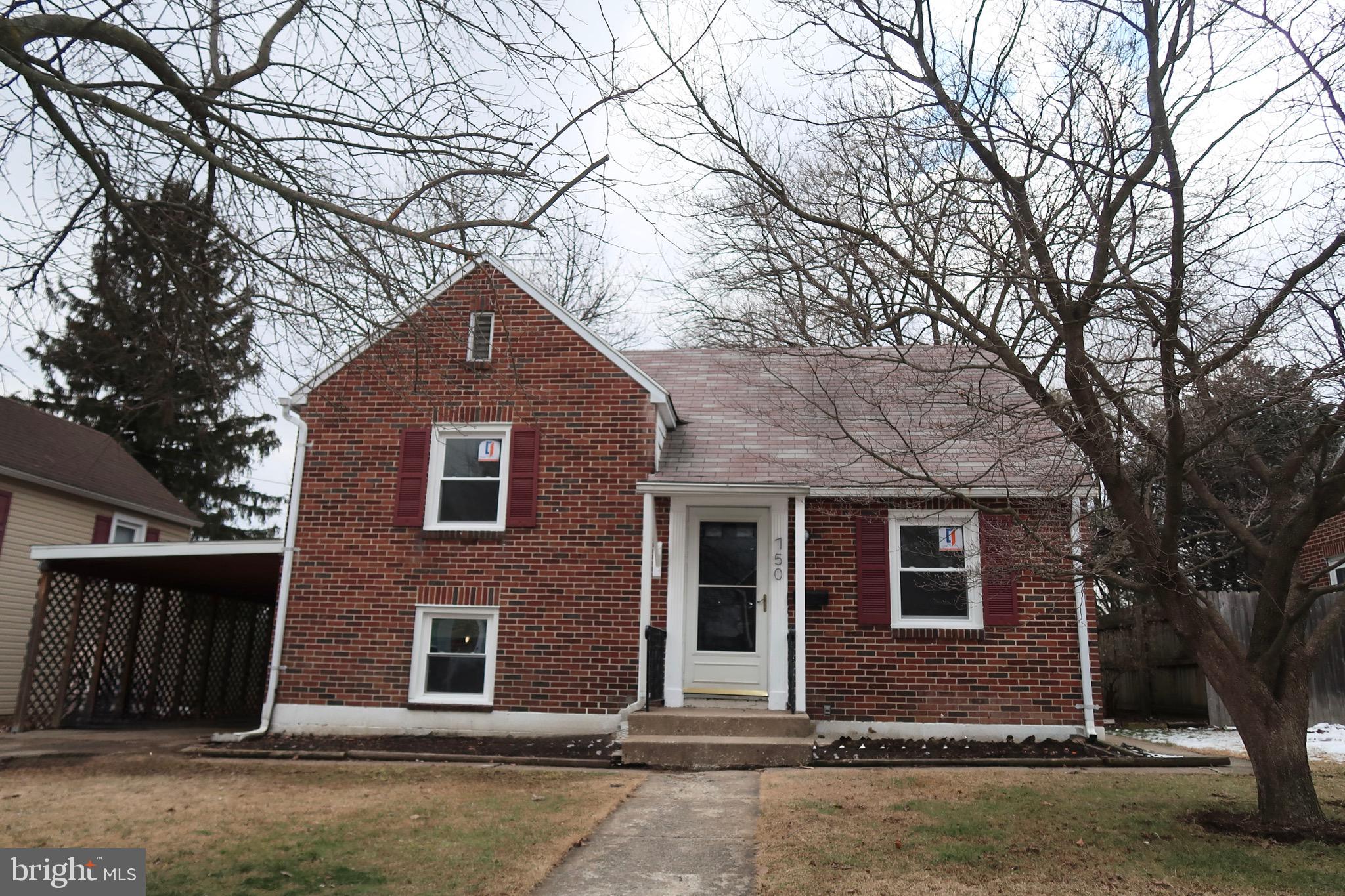 750 Oatman Street York, PA 17404 - Photo 2 of 33 a front view of a house with a yard and garage