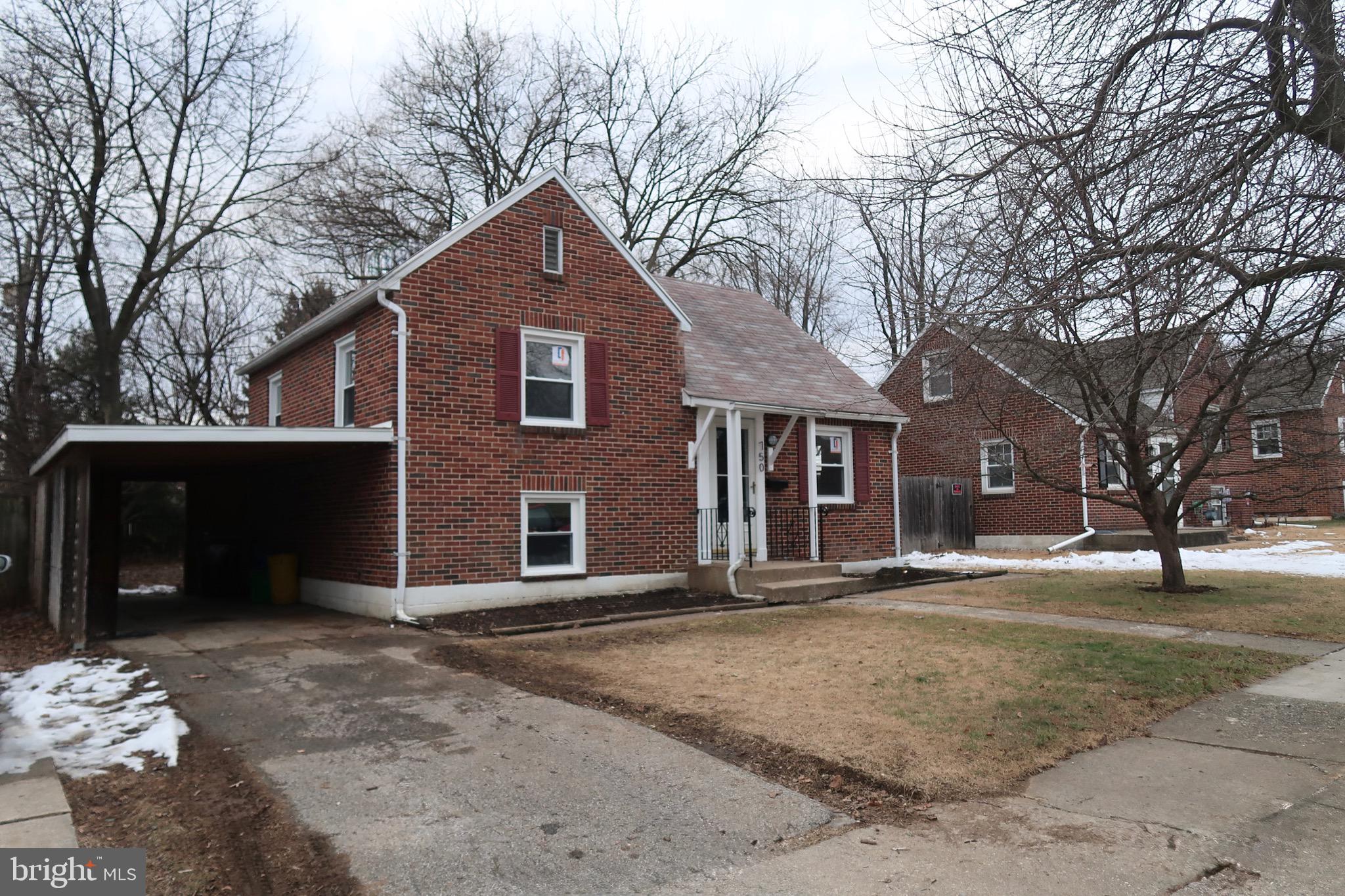 750 Oatman Street York, PA 17404 - Photo 3 of 33 a front view of a house with a yard and garage