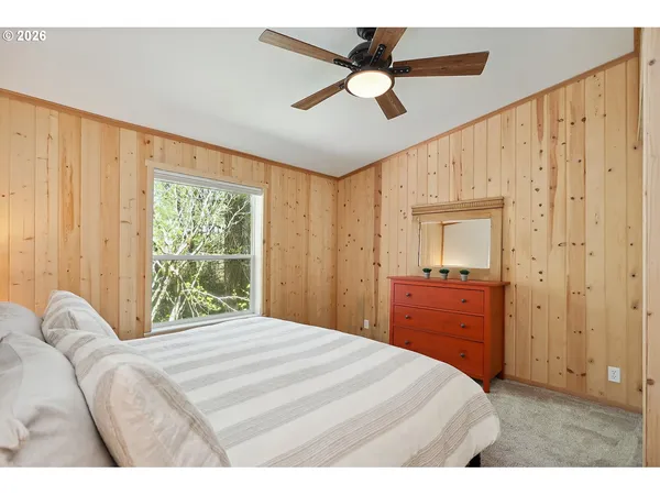 a bedroom with a large bed and a large window